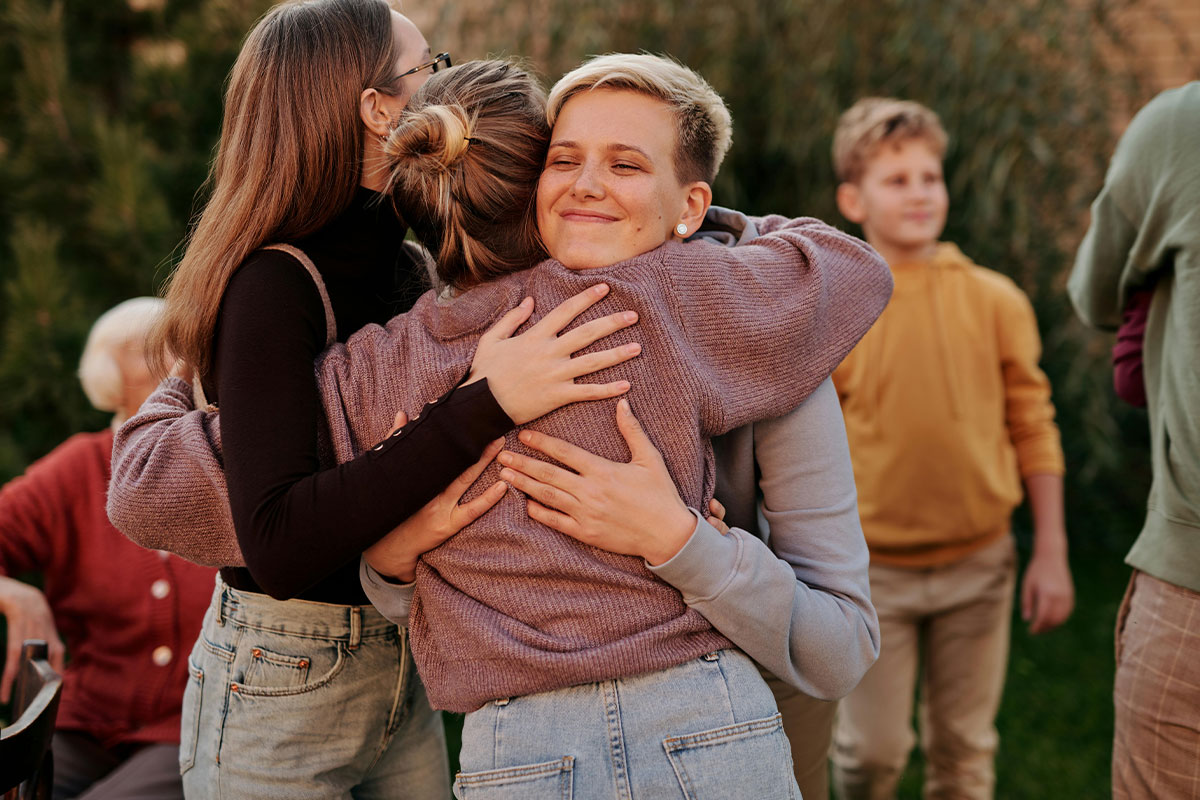 Three women hug